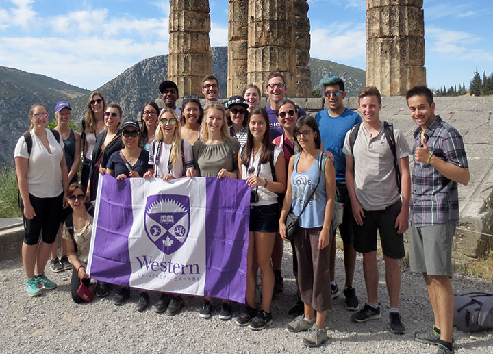 山ǿ students holding up a flag in Greece